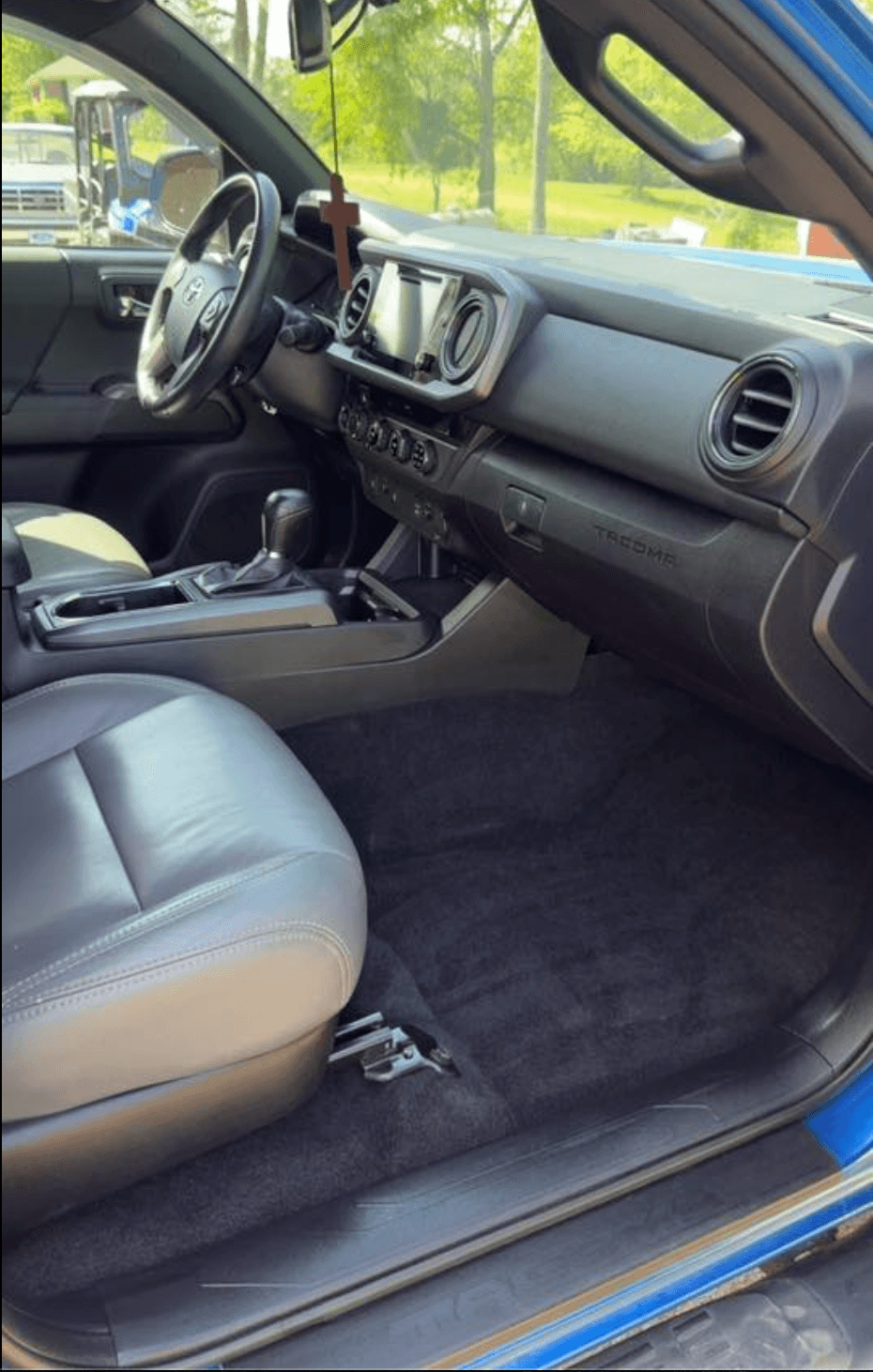 Toyota Tacoma driver and passenger floor cleaned, leather seats wiped down after interior detail
